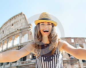 Woman making selfie in front of colosseum in rome