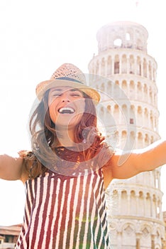 Woman making selfie in front of tower of pisa