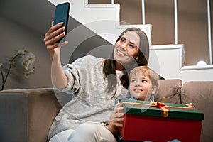 Woman making selfie with her son broadcasting livestream during New Year