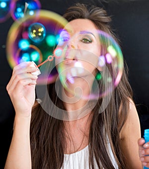 Woman making soap bubbles