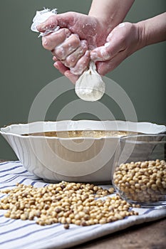 Woman making soy milk in kitchen