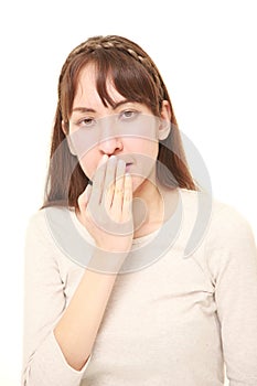 Woman making the speak no evil gesture