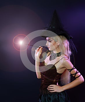 Woman making spell with magic wand