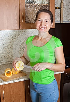 Woman making stuffed vegetable marrow
