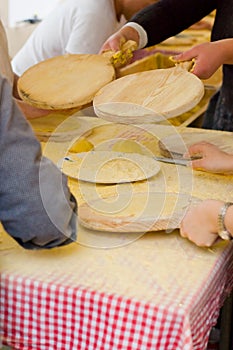 Woman Making talos, Tortilla than wraps txistorra. photo