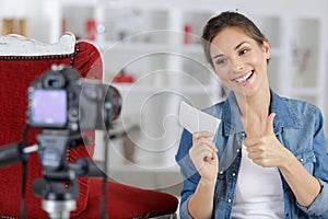 woman making thumbs up gesture while filming crafts blog