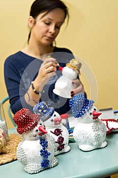 Woman making toy snowman