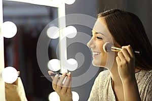 Woman making up using a brush