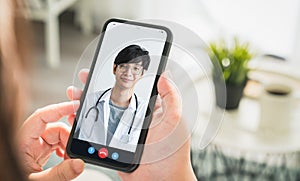 Woman making video call to doctor on smartphone and provide help online counseling.