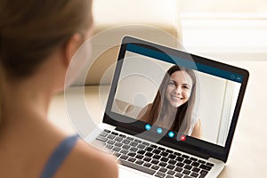 Woman making video call to female friend on laptop.