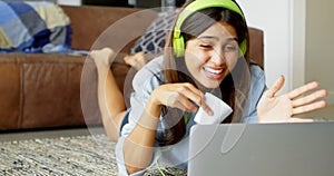 Woman making video call to friend on laptop 4k