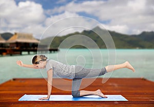 Woman making yoga in balancing table pose outdoors