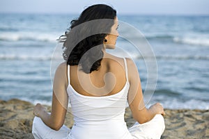 Woman making yoga exercise on the beach