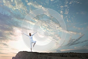 Woman making yoga exercises immersed in nature