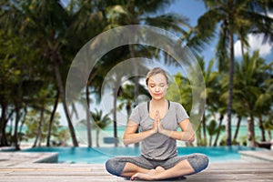 Woman making yoga meditation in lotus pose