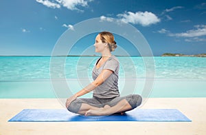 Woman making yoga in twist pose on mat