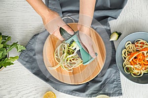 Woman making zucchini spaghetti