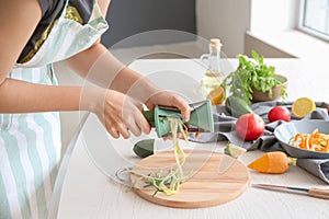 Woman making zucchini spaghetti