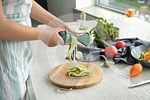 Woman making zucchini spaghetti