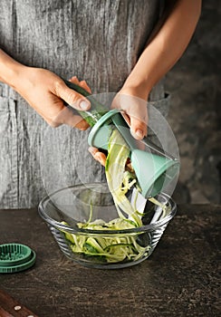 Woman making zucchini spaghetti, closeup