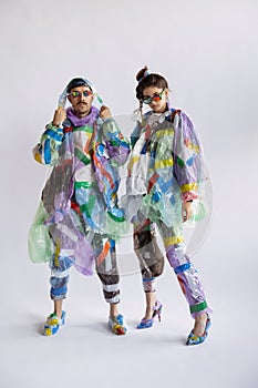 Woman and man addicted of sales and clothes, wearing plastic, recycling concept