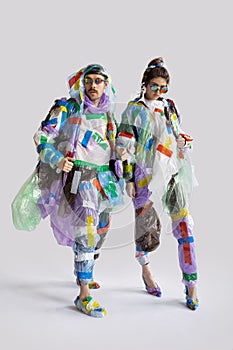 Woman and man addicted of sales and clothes, wearing plastic, recycling concept