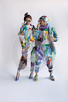 Woman and man addicted of sales and clothes, wearing plastic, recycling concept