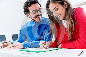 Woman and man as students working together