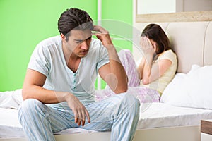 The woman and man in the bedroom after conflict