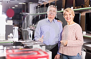 Woman and man are choosing consumer electronics photo