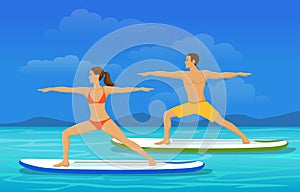 Woman and Man doing Stand Up Paddling Yoga on Paddle Board at Seaside