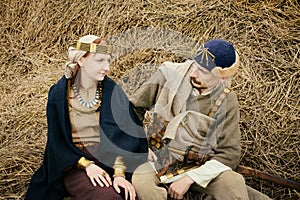 Woman and man in ethnic suit context historical reconstruction