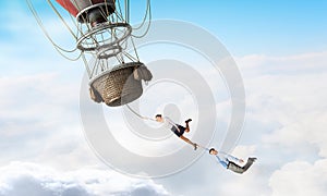 Woman and man flying on aerostat
