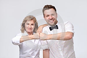 Woman and man friends give fist bump looking at camera as friendship partnership respect.