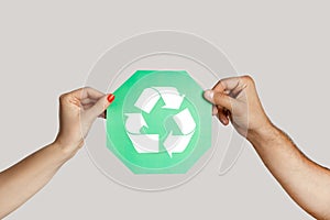 Woman and man hand holding green recycling sign, ecological icon, environment protection.