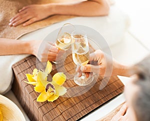 Woman and man hands with champagne glasses