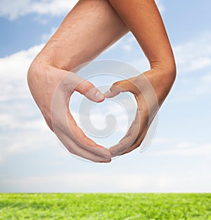 Woman and man hands showing heart shape