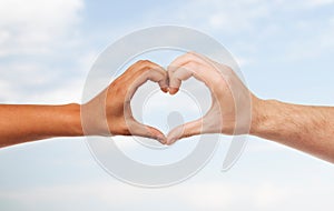 Woman and man hands showing heart shape