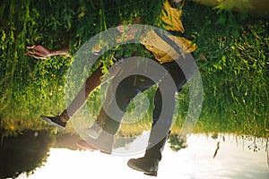 woman and man having fun outdoors. Loving hipster couple walking in the field, kissing and holding hands, hugging, lying