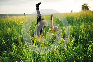 woman and man having fun outdoors. Loving hipster couple walking in the field, kissing and holding hands, hugging, lying