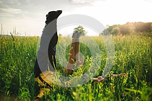 woman and man having fun outdoors. Loving hipster couple walking in the field, kissing and holding hands, hugging, lying