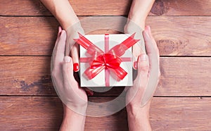 Woman with man holding a christmas gift