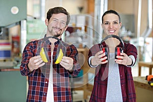 woman and man holding earprotection