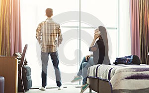 Woman and man in hotel room on vacation