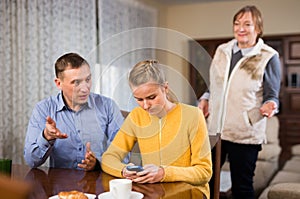 Woman and man lecturing teenage girl