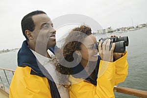 Woman With Man Looking Through Binoculars