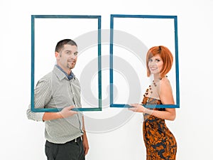 Woman and man looking through empty frames