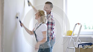 Woman and man makes repairs