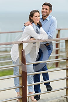 woman and man on pier at lake photo