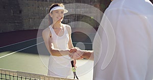 Woman and man playing tennis on a sunny day